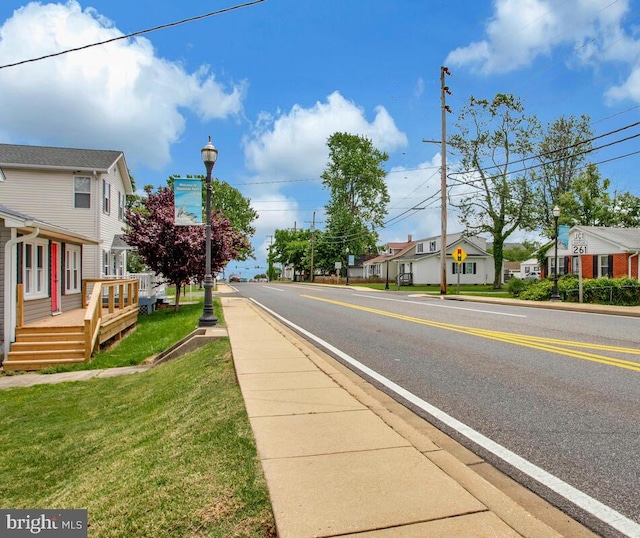 3816 Chesapeake Beach Rd, Chesapeake Beach, MD 20732 - view of asphalt road featuring street lights, sidewalks, a residential view, and curbs