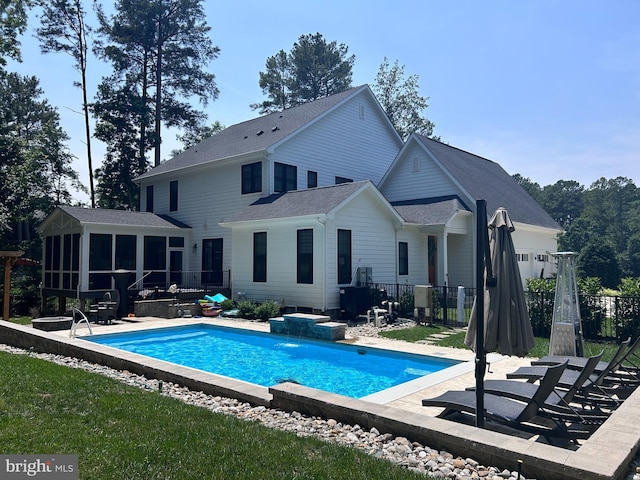 11606 Little Bay Harbor Way, Spotsylvania, VA 22551 - back of property featuring a sunroom, a jacuzzi, a patio area, and roof with shingles