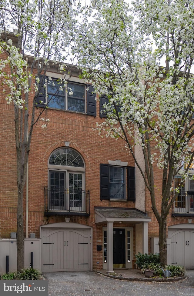 216 Christian St Unit E, Philadelphia, PA 19147 - view of building exterior featuring a garage and driveway