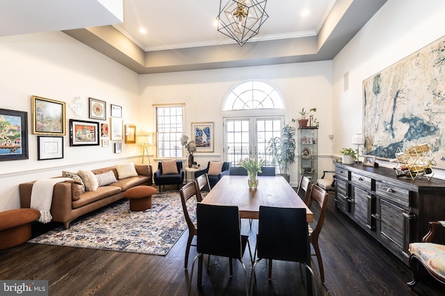 216 Christian St Unit E, Philadelphia, PA 19147 - dining space with dark wood-style flooring, a chandelier, a raised ceiling, a towering ceiling, and ornamental molding