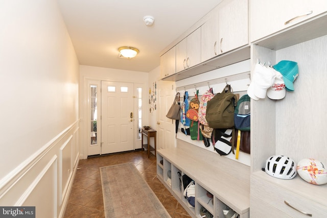 216 Christian St Unit E, Philadelphia, PA 19147 - mudroom featuring dark tile patterned floors and a wainscoted wall