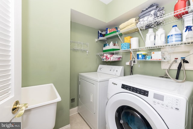 216 Christian St Unit E, Philadelphia, PA 19147 - washroom with independent washer and dryer and light tile patterned floors