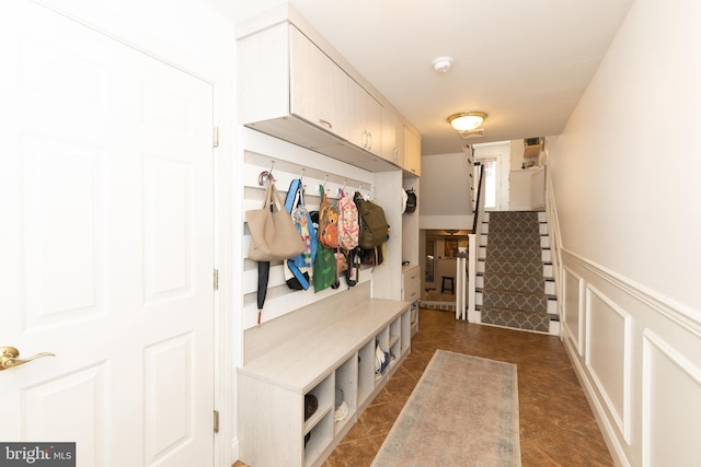 216 Christian St Unit E, Philadelphia, PA 19147 - mudroom featuring a wainscoted wall and dark tile patterned floors