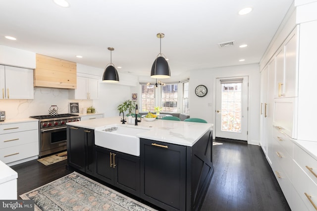 216 Christian St Unit E, Philadelphia, PA 19147 - kitchen featuring luxury stove, custom range hood, white cabinets, dark cabinetry, and recessed lighting