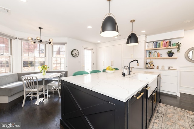 216 Christian St Unit E, Philadelphia, PA 19147 - kitchen with a chandelier, dark wood finished floors, dark cabinetry, open shelves, and decorative light fixtures