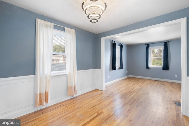 17 Alvil Rd, Wilmington, DE 19805 - spare room featuring a chandelier, plenty of natural light, and wood finished floors