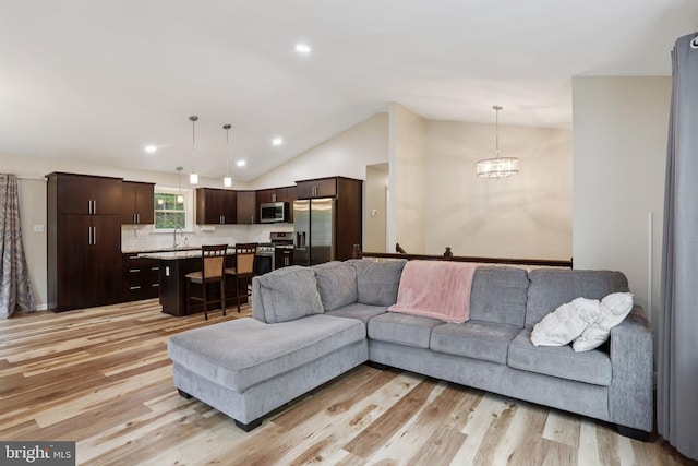 1442 Peacock Ln, Hellertown, PA 18055 - living room with lofted ceiling, light wood-type flooring, recessed lighting, and a chandelier