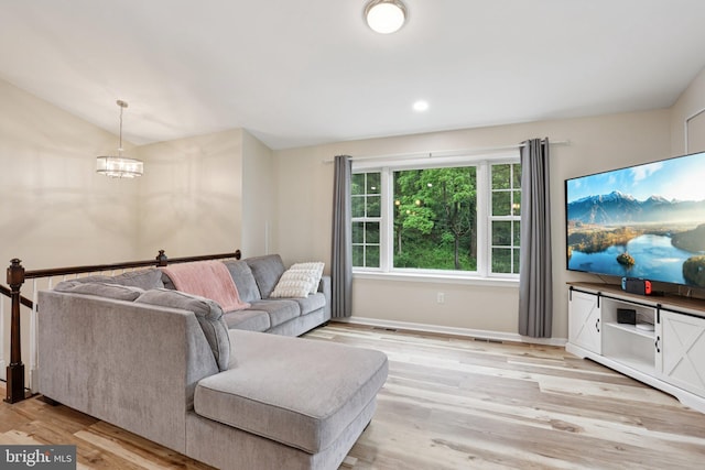 1442 Peacock Ln, Hellertown, PA 18055 - living area with light wood-type flooring, a chandelier, and vaulted ceiling