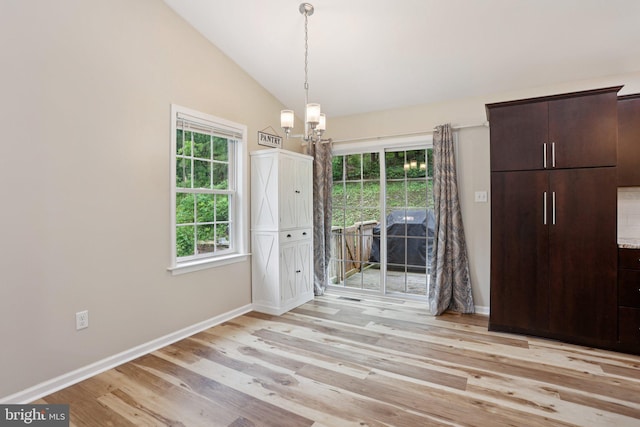 1442 Peacock Ln, Hellertown, PA 18055 - unfurnished dining area with a chandelier, light wood-style flooring, healthy amount of natural light, and vaulted ceiling