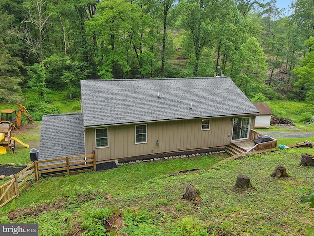 1442 Peacock Ln, Hellertown, PA 18055 - back of property with a shingled roof, a wooden deck, and a wooded view
