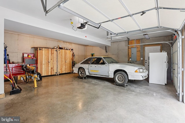 1442 Peacock Ln, Hellertown, PA 18055 - garage with electric panel, freestanding refrigerator, and a garage door opener