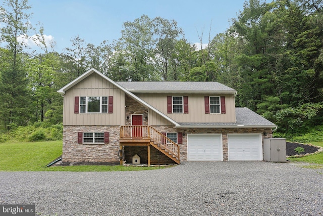 1442 Peacock Ln, Hellertown, PA 18055 - bi-level home with driveway, stone siding, roof with shingles, and a front yard
