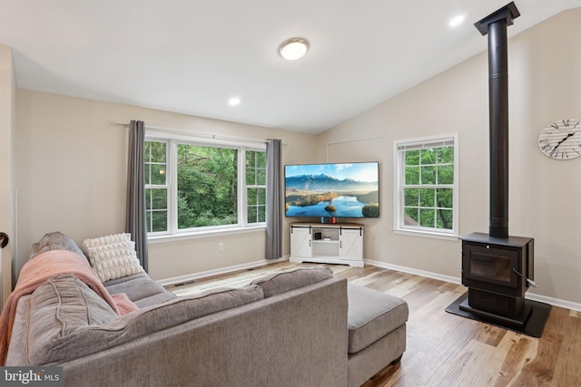 1442 Peacock Ln, Hellertown, PA 18055 - living area featuring a wood stove, healthy amount of natural light, wood finished floors, vaulted ceiling, and recessed lighting