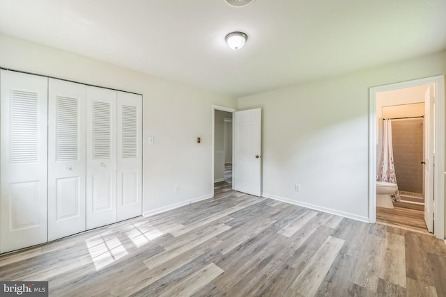 10401 W Huguenot Rd, North Chesterfield, VA 23224 - unfurnished bedroom with wood finished floors, a closet, and ensuite bathroom