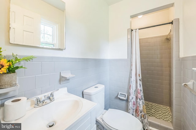 10401 W Huguenot Rd, North Chesterfield, VA 23224 - bathroom featuring tiled shower, tile walls, a wainscoted wall, and vanity