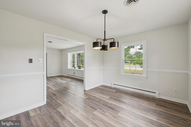 10401 W Huguenot Rd, North Chesterfield, VA 23224 - unfurnished room featuring baseboard heating, wood finished floors, and a chandelier