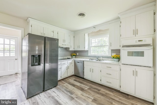 10401 W Huguenot Rd, North Chesterfield, VA 23224 - kitchen with appliances with stainless steel finishes, under cabinet range hood, light countertops, light wood-style floors, and backsplash