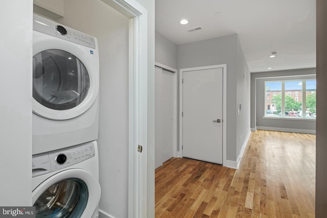 1640 Cambridge St, Philadelphia, PA 19130 - laundry area with stacked washing machine and dryer, light wood-type flooring, and recessed lighting