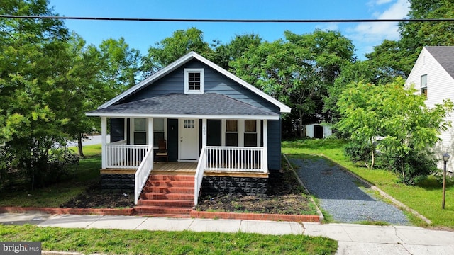 405 Washington St, Salisbury, MD 21804 - bungalow-style home featuring a shingled roof, covered porch, and gravel driveway