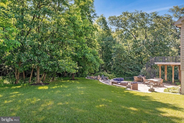 43858 Grantner Pl, Ashburn, VA 20147 - view of green lawn with stairs, a patio, an outdoor living space with a fire pit, and a wooden deck