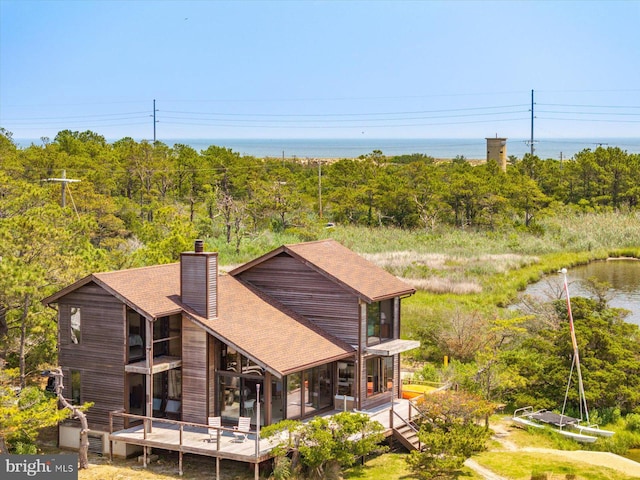 35197 Hassell Ave, Bethany Beach, DE 19930 - back of property with a chimney, a shingled roof, and a water view