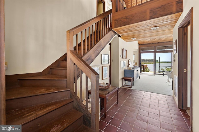 35197 Hassell Ave, Bethany Beach, DE 19930 - stairway featuring carpet, tile patterned floors, and a water view