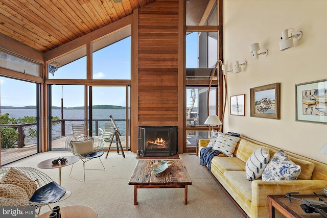 35197 Hassell Ave, Bethany Beach, DE 19930 - carpeted living area featuring high vaulted ceiling, a water view, plenty of natural light, wooden ceiling, and a lit fireplace