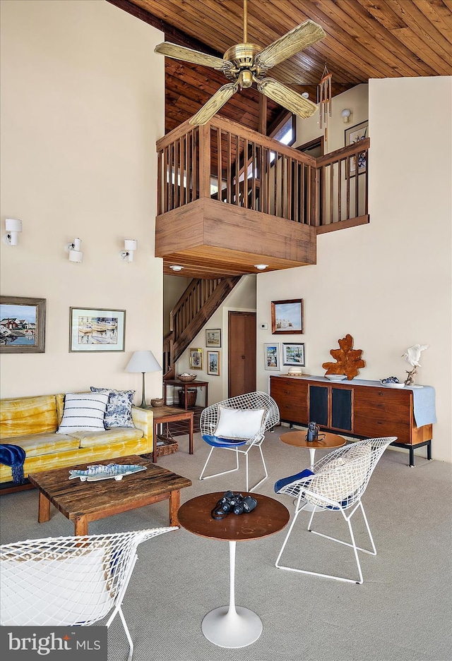 35197 Hassell Ave, Bethany Beach, DE 19930 - carpeted living area with high vaulted ceiling, a ceiling fan, stairs, and wooden ceiling