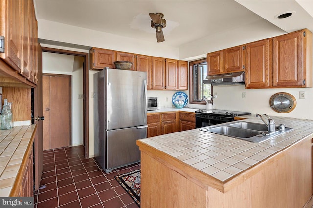 35197 Hassell Ave, Bethany Beach, DE 19930 - kitchen with freestanding refrigerator, tile countertops, under cabinet range hood, and black range with electric cooktop