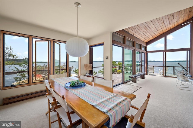 35197 Hassell Ave, Bethany Beach, DE 19930 - dining space featuring a baseboard radiator, light colored carpet, a water view, wooden ceiling, and vaulted ceiling