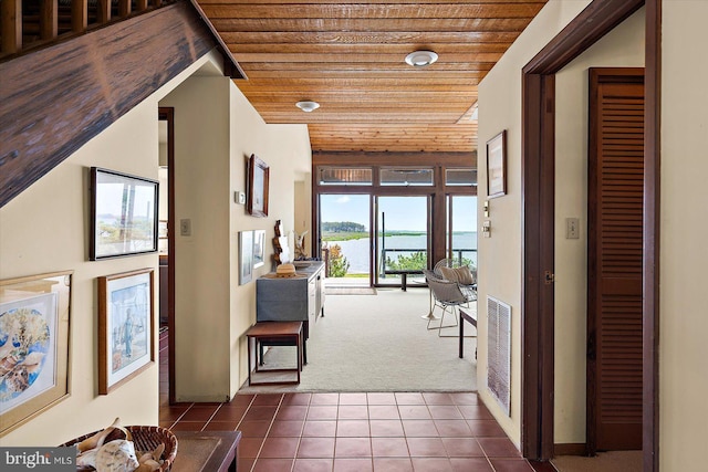 35197 Hassell Ave, Bethany Beach, DE 19930 - hall with wooden ceiling, dark colored carpet, a water view, and dark tile patterned flooring