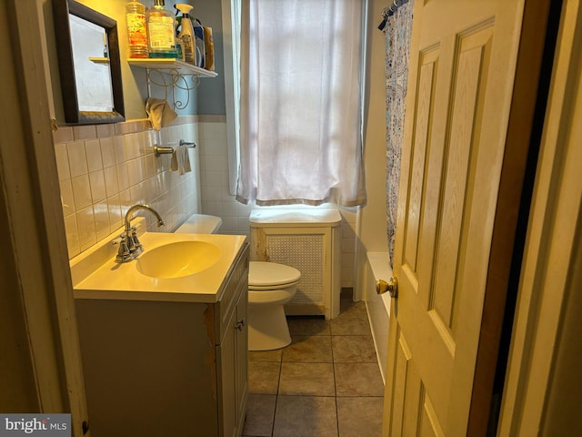 2228 Manor Ave, Upper Darby, PA 19082 - bathroom featuring tile patterned flooring, vanity, tile walls, and a wainscoted wall