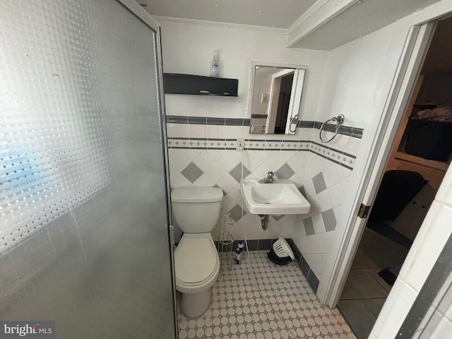 2228 Manor Ave, Upper Darby, PA 19082 - bathroom featuring ornamental molding, tile walls, and a wainscoted wall