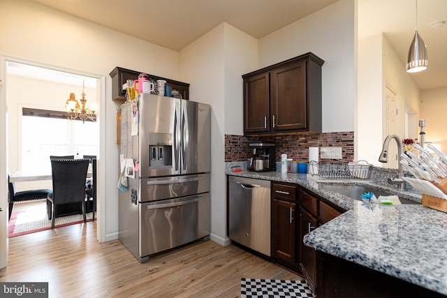 55 Hamlet Cir, Mechanicsburg, PA 17050 - kitchen with stainless steel appliances, light wood-style flooring, dark brown cabinetry, light stone countertops, and a chandelier