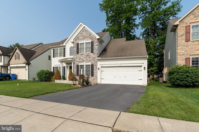 55 Hamlet Cir, Mechanicsburg, PA 17050 - view of front of home with stone siding, asphalt driveway, an attached garage, a front lawn, and a shingled roof