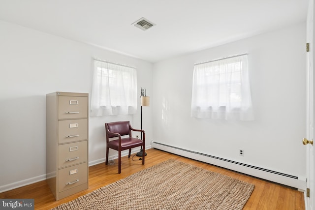 1243 Grove Rd, West Chester, PA 19380 - living area featuring a baseboard heating unit and wood finished floors