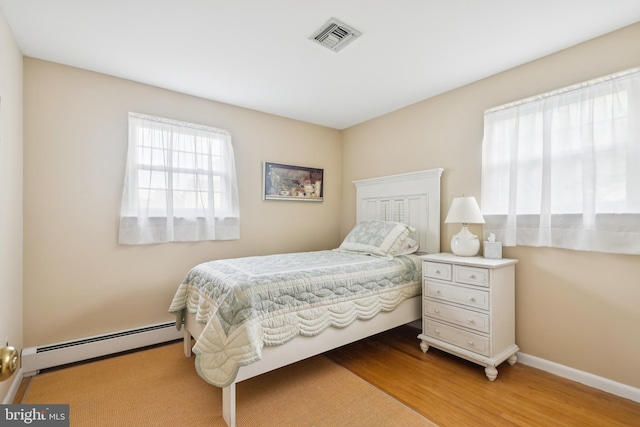 1243 Grove Rd, West Chester, PA 19380 - bedroom featuring a baseboard heating unit and wood finished floors