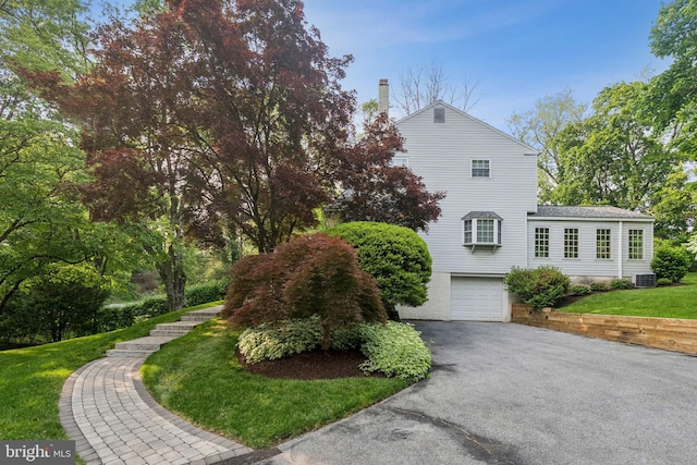1243 Grove Rd, West Chester, PA 19380 - view of front facade with a garage, driveway, a front yard, and a chimney