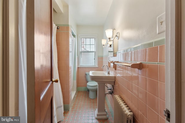1606 W Mcgalliard Ave, Hamilton, NJ 08610 - bathroom with radiator, tile walls, a shower with shower curtain, tile patterned floors, and wainscoting