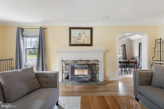 1606 W Mcgalliard Ave, Hamilton, NJ 08610 - living room featuring arched walkways, a fireplace with flush hearth, wood finished floors, and ornamental molding