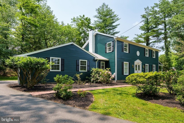 92 Lochatong Rd, Ewing, NJ 08628 - colonial inspired home with a chimney and a front lawn