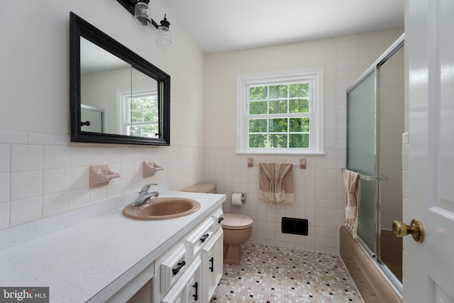 92 Lochatong Rd, Ewing, NJ 08628 - bathroom featuring vanity, tile walls, a wainscoted wall, shower / bath combination with glass door, and tile patterned floors
