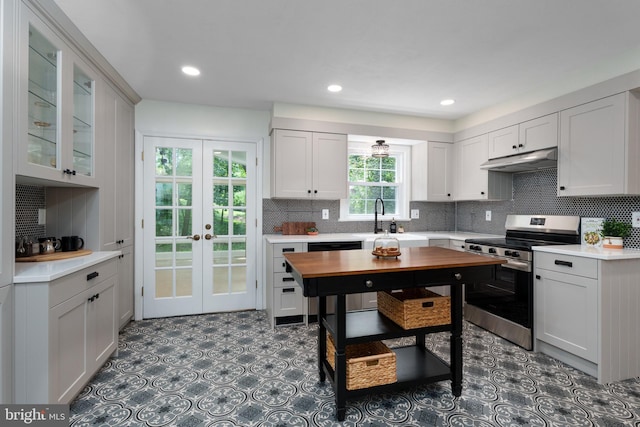 92 Lochatong Rd, Ewing, NJ 08628 - kitchen with stainless steel range, under cabinet range hood, french doors, dishwasher, and light countertops