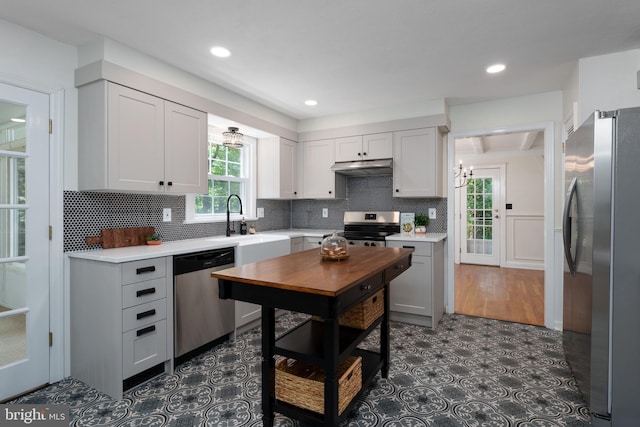 92 Lochatong Rd, Ewing, NJ 08628 - kitchen featuring stainless steel appliances, under cabinet range hood, healthy amount of natural light, light countertops, and recessed lighting