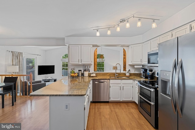 1908 Brigade Way, Odenton, MD 21113 - kitchen featuring stainless steel appliances, a peninsula, white cabinets, light wood-style flooring, and dark stone countertops