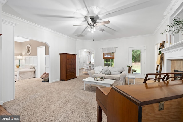 11871 Knollcrest Ln, La Plata, MD 20646 - living room featuring arched walkways, a ceiling fan, crown molding, a tiled fireplace, and carpet