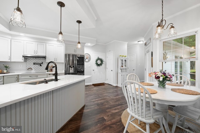 11871 Knollcrest Ln, La Plata, MD 20646 - kitchen with stainless steel fridge, ornamental molding, light countertops, dark wood-style floors, and decorative backsplash