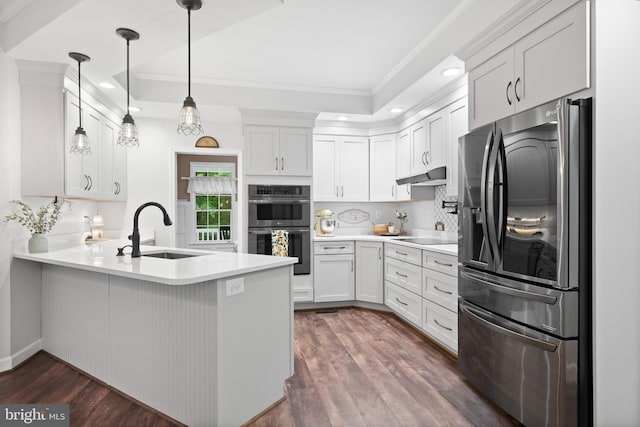 11871 Knollcrest Ln, La Plata, MD 20646 - kitchen with appliances with stainless steel finishes, a peninsula, ornamental molding, recessed lighting, and dark wood-style floors