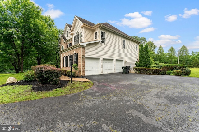 7412 Kallenburg Ct, Manassas, VA 20111 - view of home's exterior with an attached garage, driveway, and brick siding