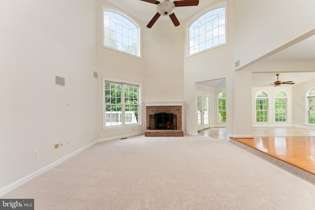 7412 Kallenburg Ct, Manassas, VA 20111 - unfurnished living room with a ceiling fan, plenty of natural light, carpet flooring, and a towering ceiling